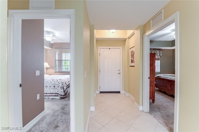 hallway featuring light colored carpet