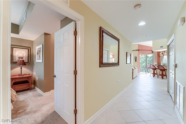 hall featuring light tile patterned floors