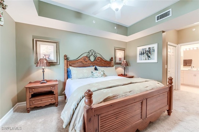 carpeted bedroom featuring ceiling fan and connected bathroom