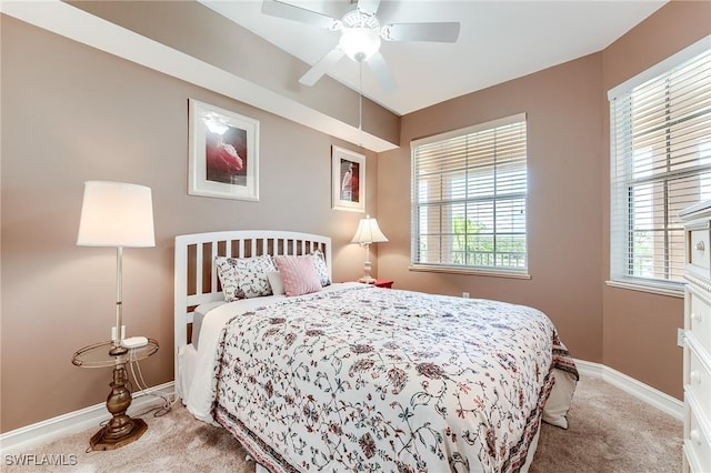 bedroom with ceiling fan, multiple windows, and carpet floors