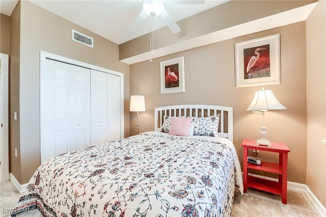 bedroom featuring ceiling fan, light colored carpet, and a closet