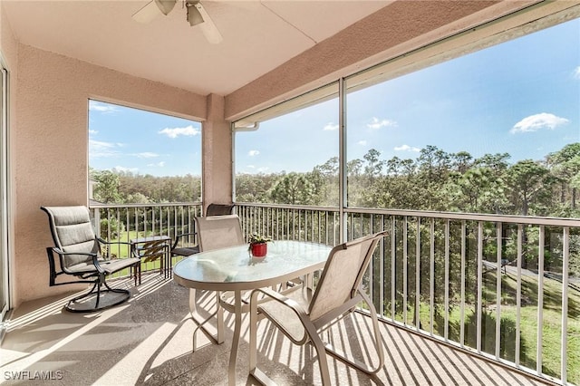 sunroom featuring ceiling fan