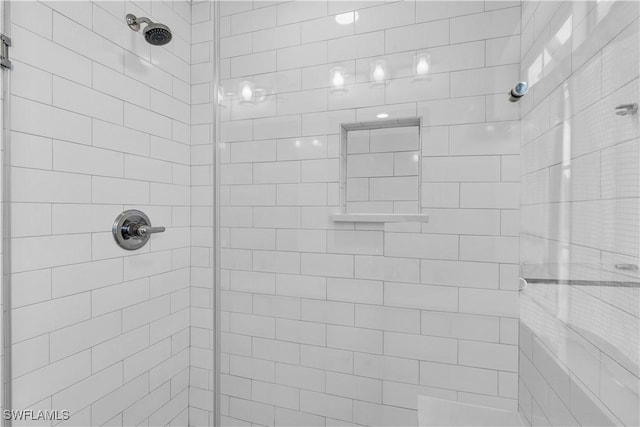 full bath with a tile shower