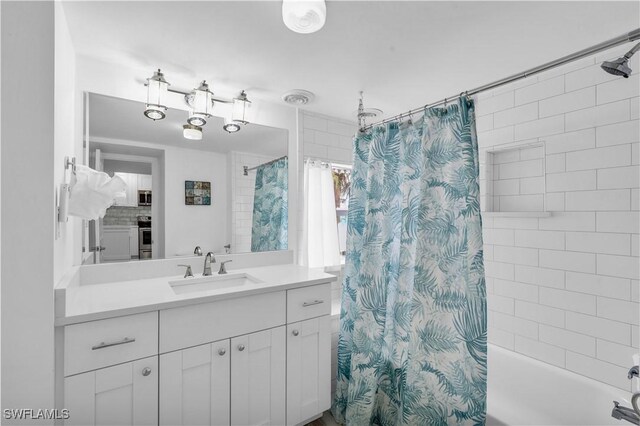 bathroom with vanity and shower / bath combo with shower curtain