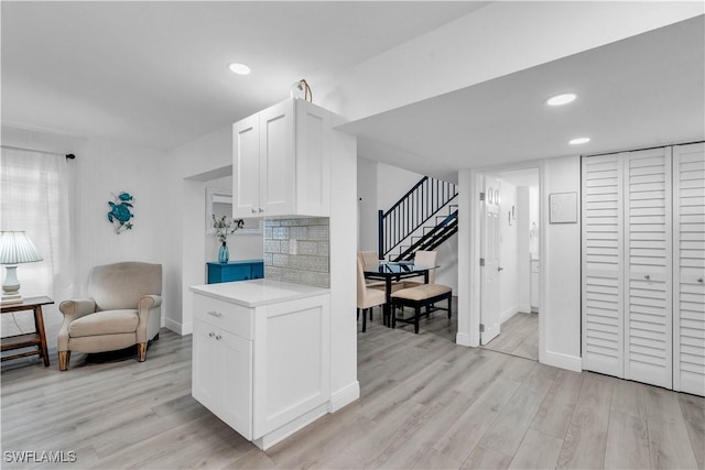 kitchen with light wood-style floors, white cabinets, and light countertops