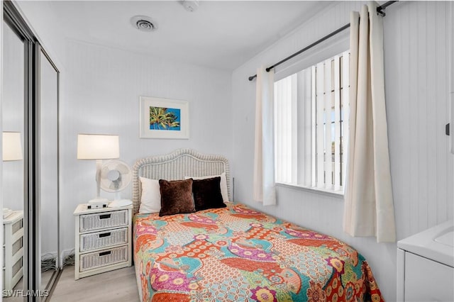 bedroom with visible vents and light wood finished floors