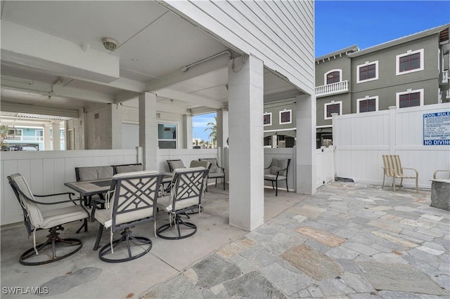 view of patio featuring outdoor dining area and fence