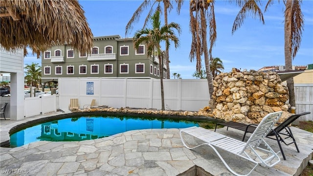 view of pool with a patio area, fence, and a fenced in pool