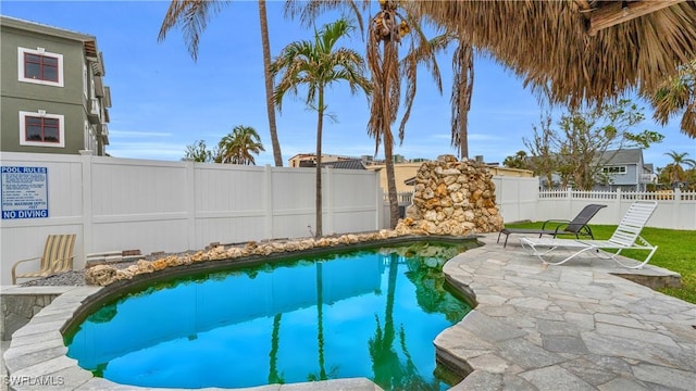 view of pool with a patio area, a fenced backyard, and a fenced in pool