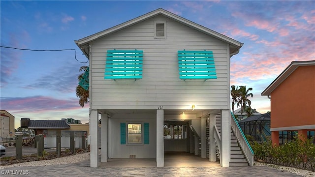 back house at dusk with a carport