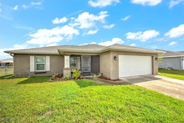 view of front of home with a front yard and a garage