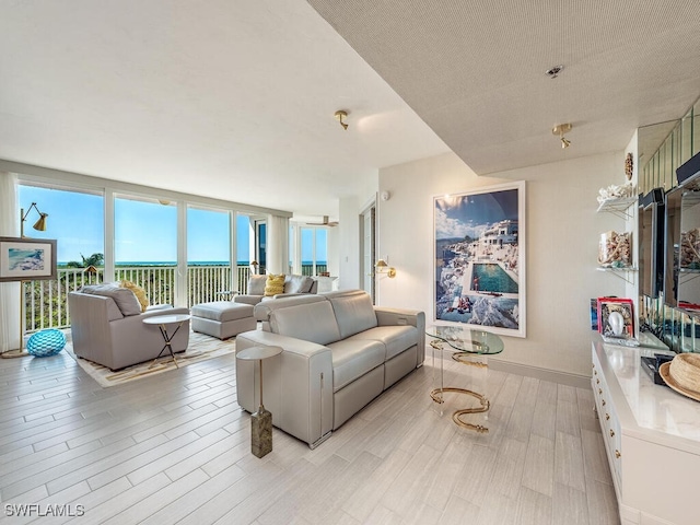 living room with light hardwood / wood-style floors and a textured ceiling