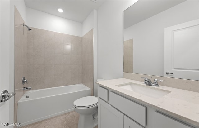 full bathroom featuring tile patterned flooring, vanity, toilet, and tiled shower / bath