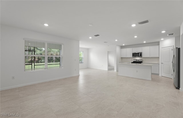 unfurnished living room with light tile patterned floors