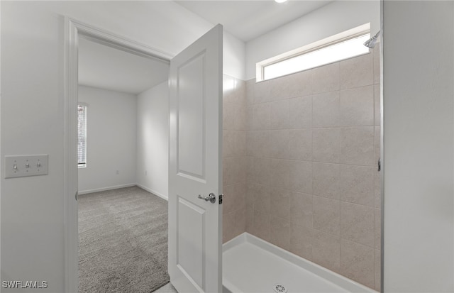 bathroom with a tile shower