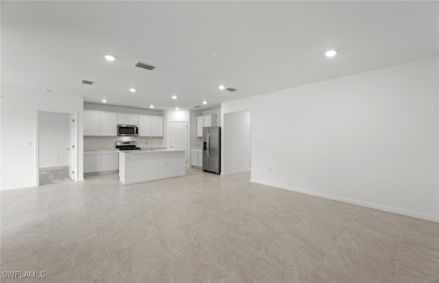 unfurnished living room featuring sink