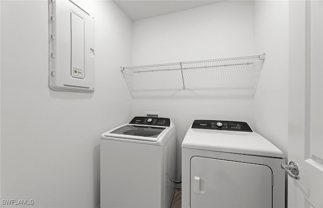 washroom with separate washer and dryer and electric panel