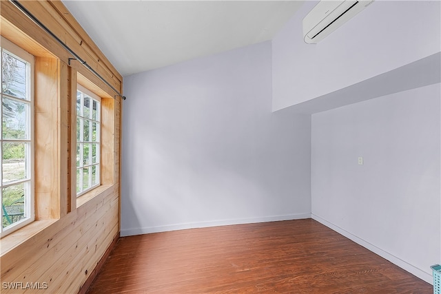 spare room with plenty of natural light, dark wood-type flooring, and a wall mounted air conditioner