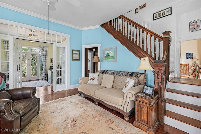 living room with dark hardwood / wood-style floors, ceiling fan, crown molding, and french doors