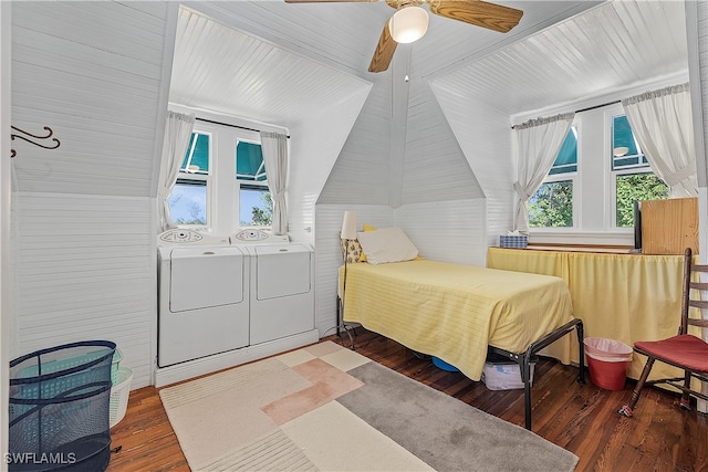 bedroom featuring independent washer and dryer, dark hardwood / wood-style floors, vaulted ceiling, and ceiling fan