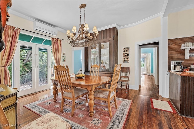 dining area with a wall mounted air conditioner, french doors, dark hardwood / wood-style flooring, ornamental molding, and a notable chandelier