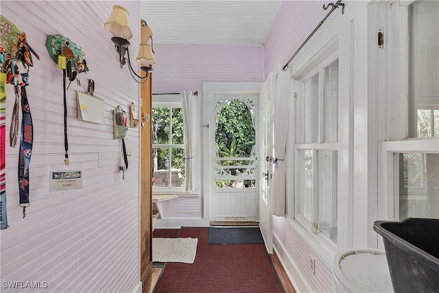 doorway with wooden walls