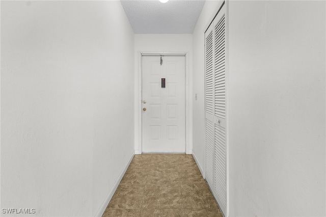 corridor featuring a textured ceiling