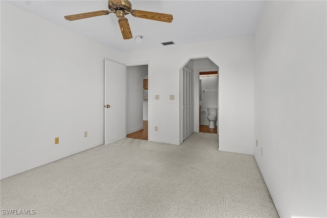 unfurnished bedroom with ceiling fan and light carpet