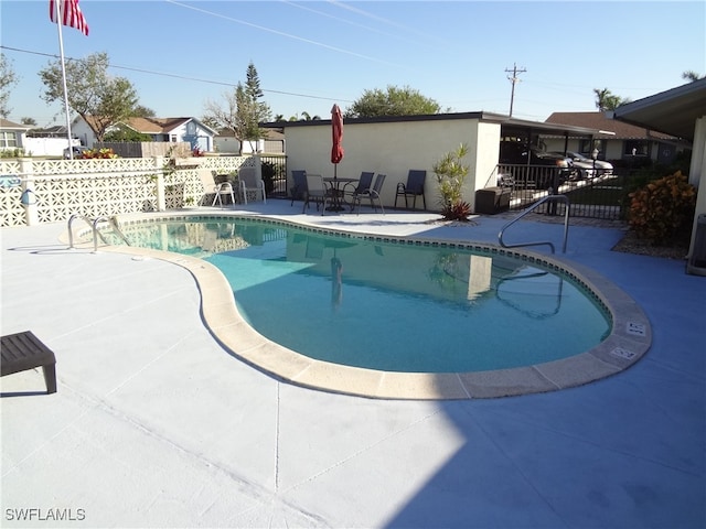 view of swimming pool with a patio