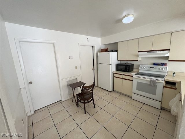 kitchen with cream cabinets, white appliances, and light tile patterned floors