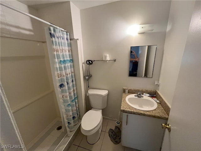 bathroom featuring tile patterned flooring, vanity, toilet, and walk in shower