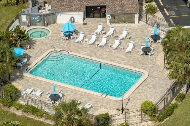 view of pool featuring a patio area and a hot tub