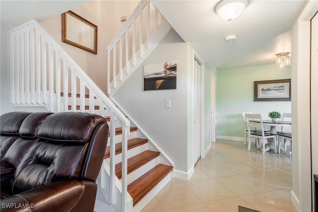 staircase featuring tile patterned flooring