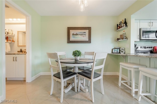 dining space featuring light tile patterned floors