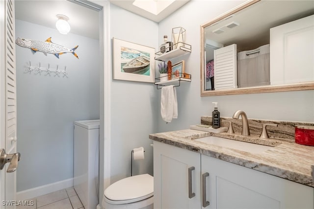 bathroom with tile patterned flooring, vanity, and toilet