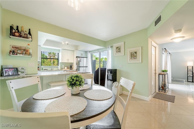 dining area featuring light tile patterned floors