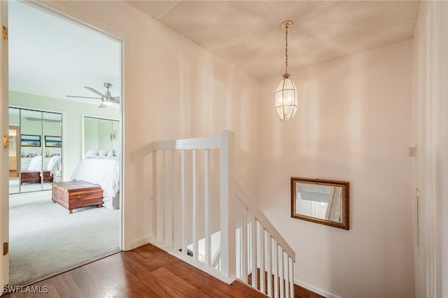 hall featuring hardwood / wood-style flooring and an inviting chandelier