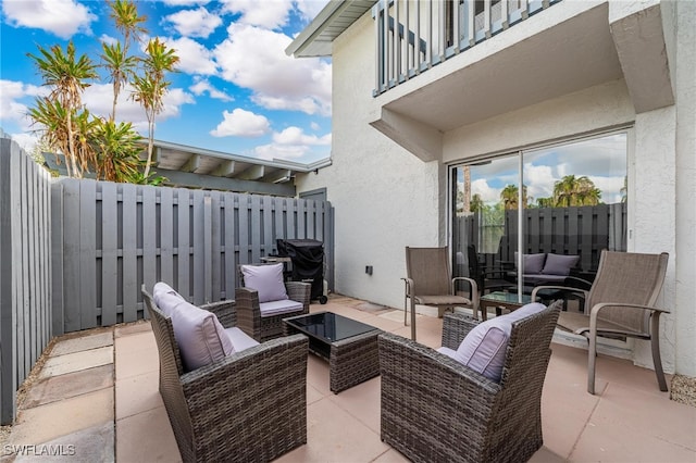 view of patio featuring an outdoor living space and a balcony