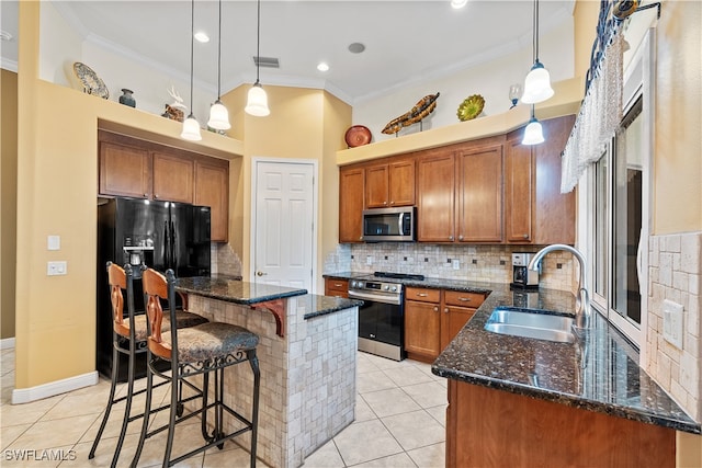 kitchen featuring sink, crown molding, hanging light fixtures, decorative backsplash, and appliances with stainless steel finishes