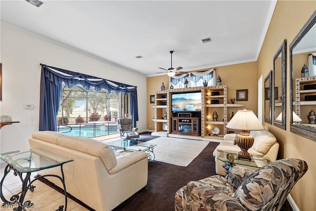 living room with ceiling fan, crown molding, and carpet floors