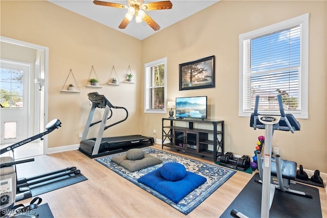 exercise area with ceiling fan and hardwood / wood-style flooring