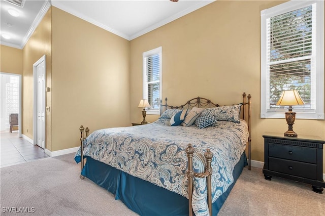 carpeted bedroom featuring baseboards, visible vents, and crown molding