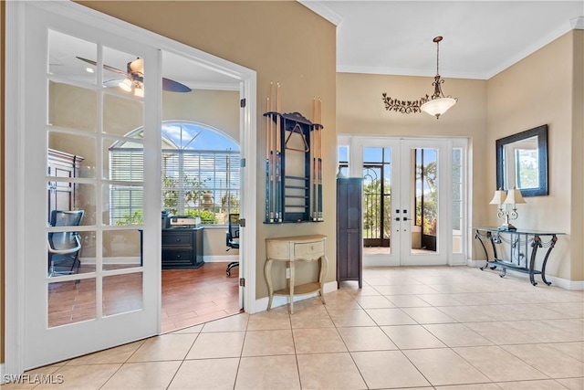 doorway to outside with ceiling fan, light tile patterned floors, crown molding, and french doors