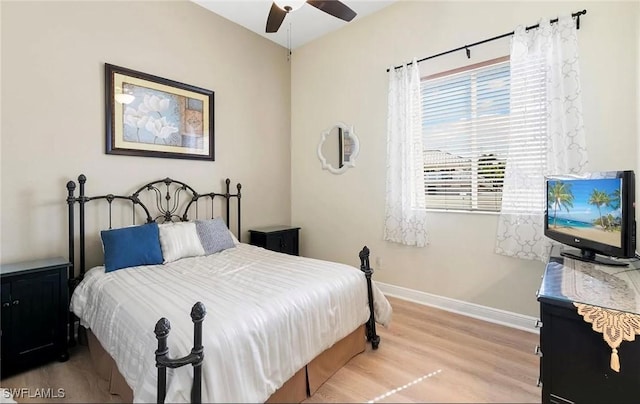 bedroom with light hardwood / wood-style floors and ceiling fan