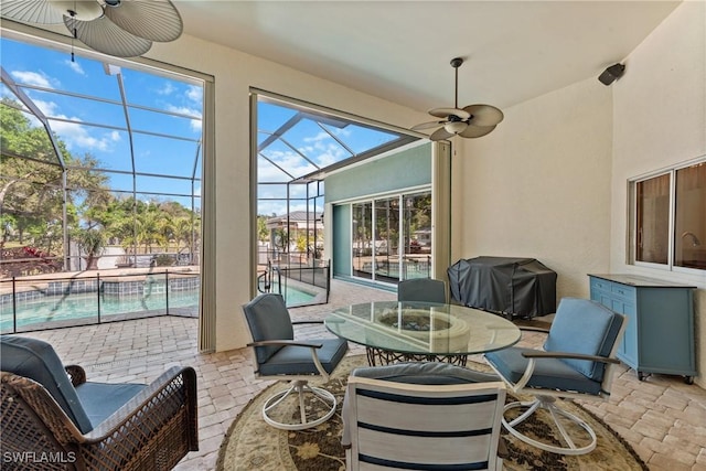 sunroom / solarium featuring ceiling fan