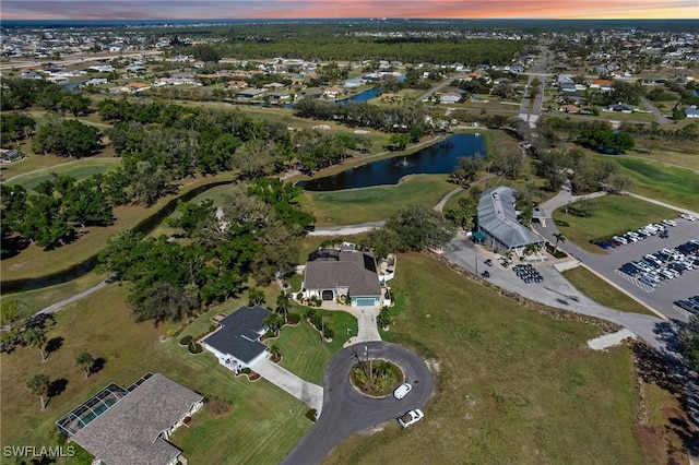 aerial view at dusk with a water view