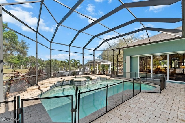 view of pool featuring a patio area, a lanai, and a pool with connected hot tub