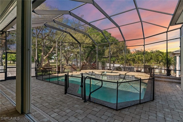 view of swimming pool with a lanai, a patio area, and a pool with connected hot tub