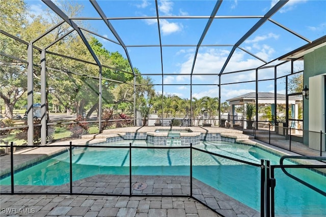 view of swimming pool featuring a pool with connected hot tub, glass enclosure, a patio, and a gazebo