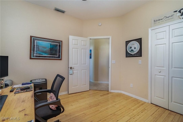 office with light wood-type flooring